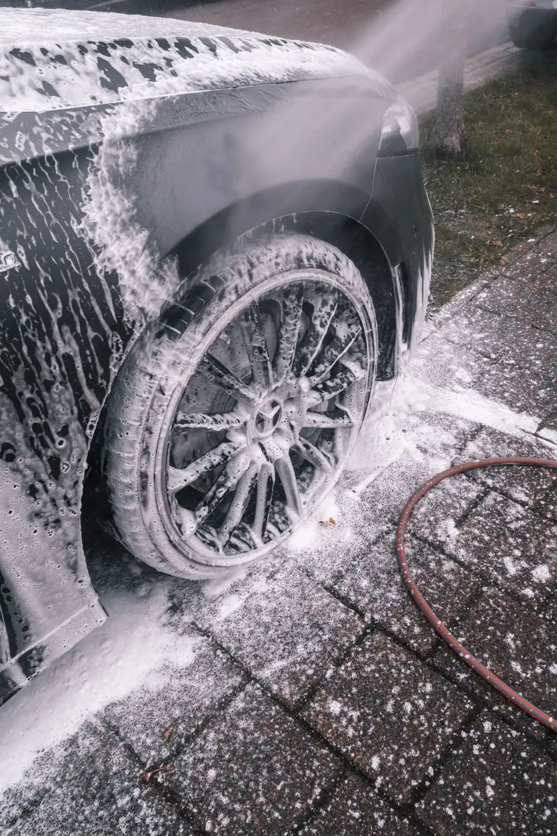 Wash foam on a wheel parked on pavers