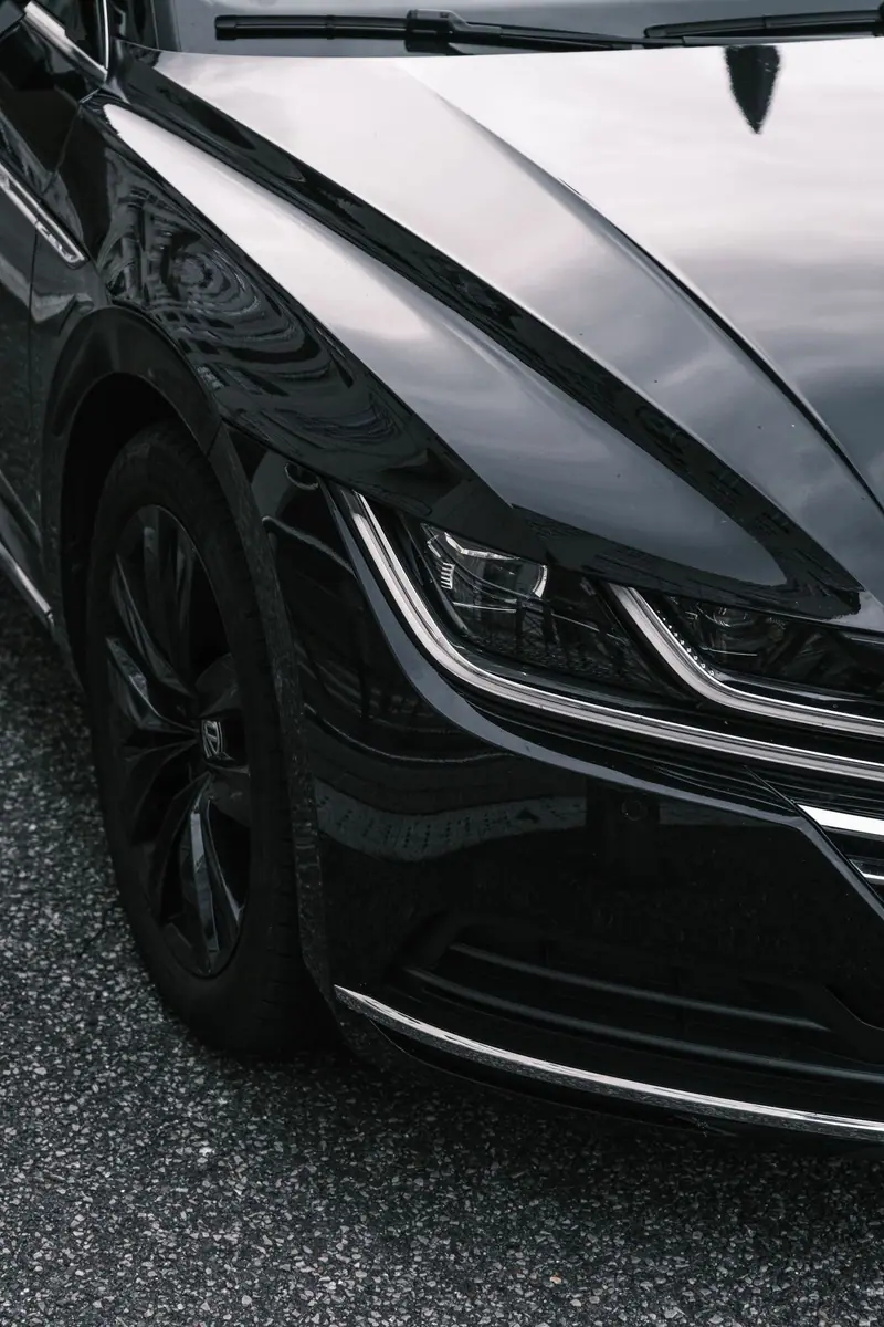 Front quarter of a black car with deep, glossy paint