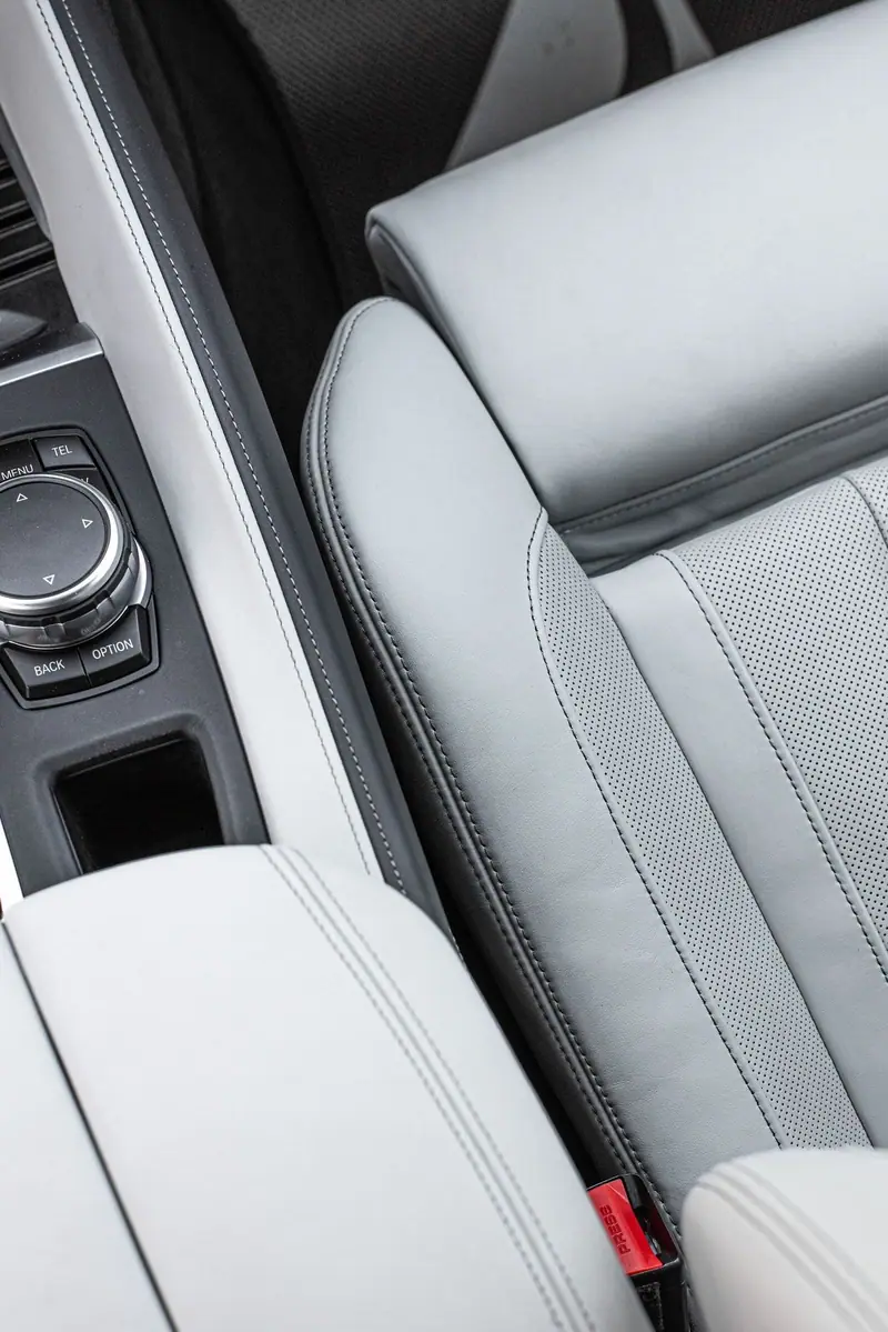 Pale grey leather seat and console after an interior detail