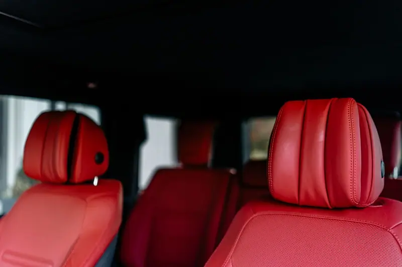Red leather seats and headrests in a clean rear cabin