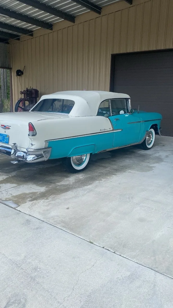 Turquoise and white classic Chevrolet Bel Air convertible gleaming in a driveway after a detail