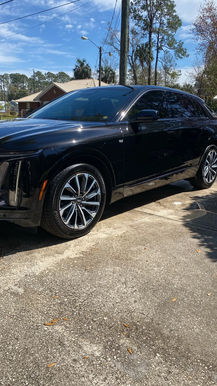 Black Cadillac crossover with a mirror finish after a detail